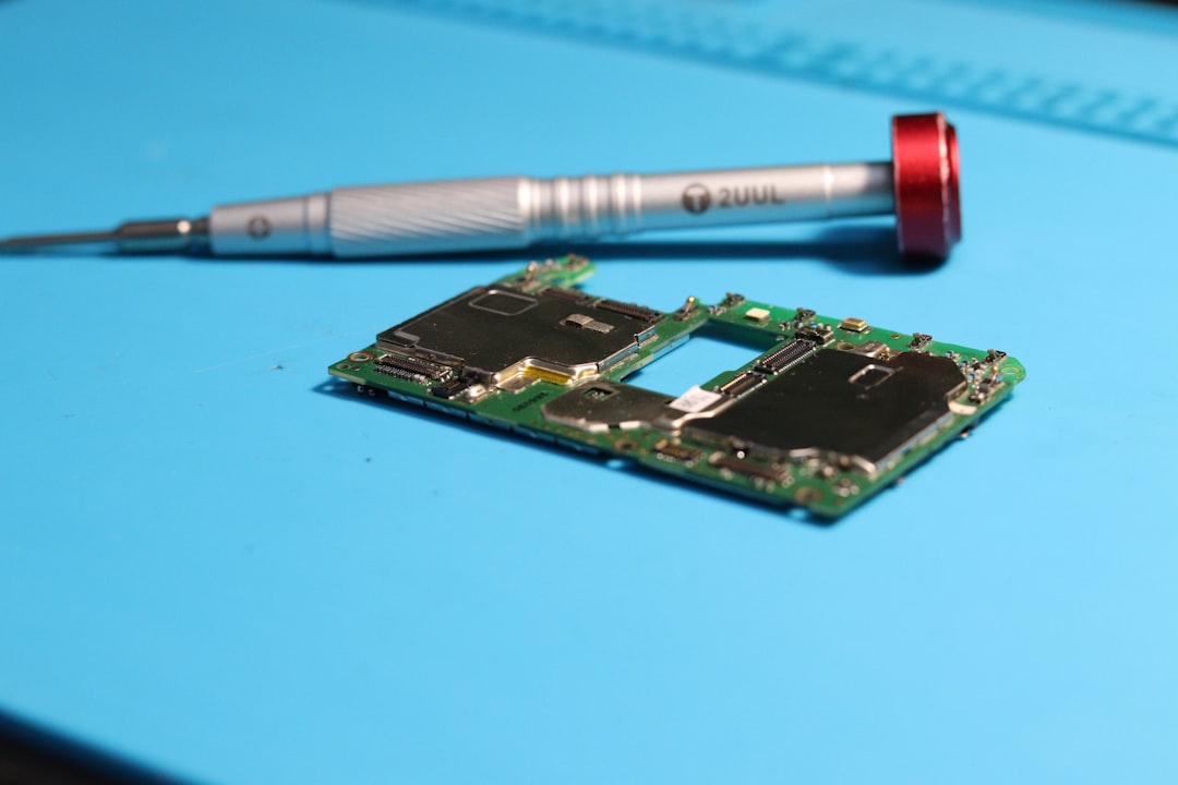 A circuit board is near a screwdriver.