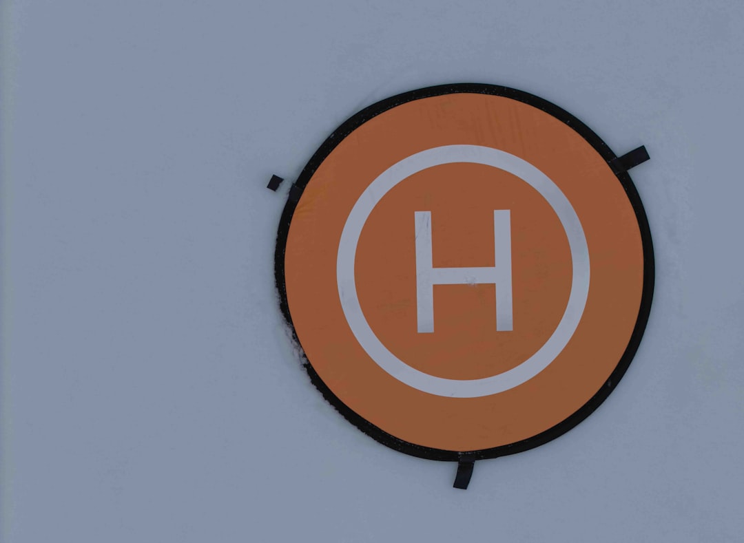 Orange helipad with white h symbol