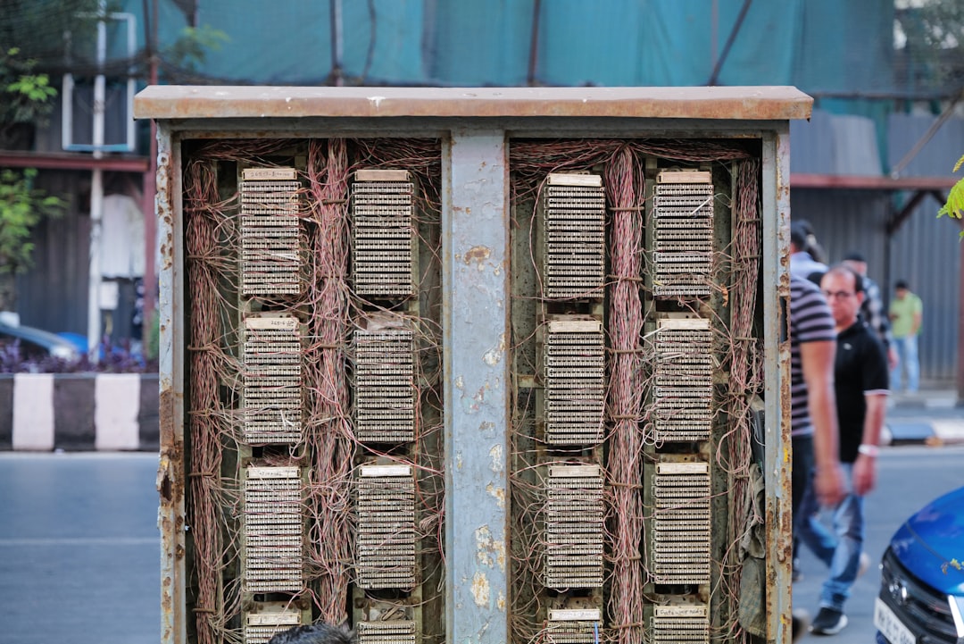 Old telephone switchboard with many wires.