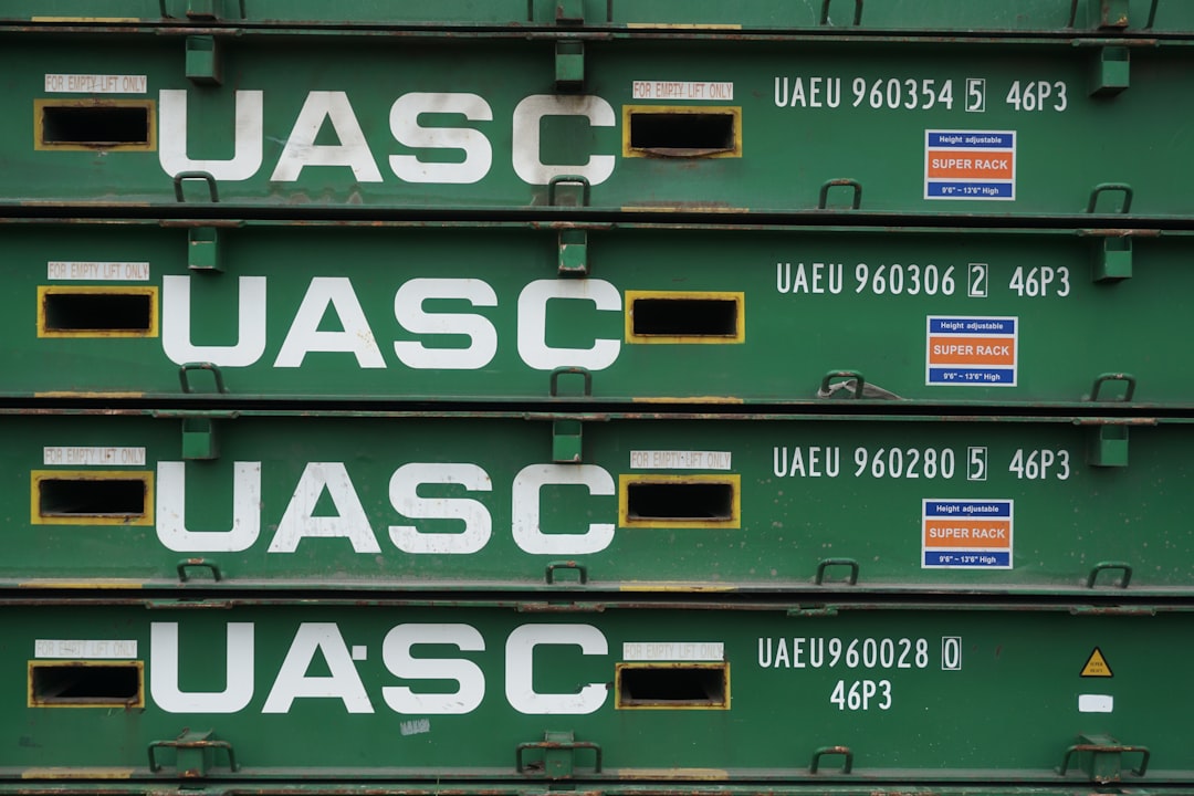 a stack of green containers with white letters on them
